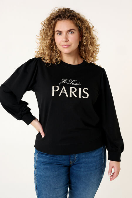 Suéter "París" y detalles de botones en el hombro.